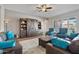 Comfortable living room featuring plush seating, a ceiling fan, and an oversized decorative cabinet at 2928 E Palm St, Mesa, AZ 85213