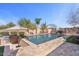 Backyard pool with patio, BBQ, and lounge area perfect for entertaining, all set under a clear blue sky at 2928 E Palm St, Mesa, AZ 85213