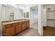 Bathroom featuring dual sinks, granite countertops, modern fixtures and a walk-in closet at 33575 N Dove Lakes Dr # 2028, Cave Creek, AZ 85331