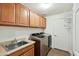 Laundry room features a stainless-steel washer and dryer, ample cabinets, and a utility sink at 33575 N Dove Lakes Dr # 2028, Cave Creek, AZ 85331