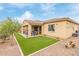 Rear exterior view shows the covered patio, low-maintenance landscaping and gravel borders at 3408 S 184Th Ln, Goodyear, AZ 85338