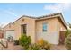 Side view of a stucco house with well-maintained desert landscaping, adding to the home's charm at 3408 S 184Th Ln, Goodyear, AZ 85338