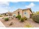 Side view of home with desert landscaping, complemented by a stucco exterior and brick driveway at 3408 S 184Th Ln, Goodyear, AZ 85338