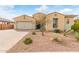 Charming single-story home showcasing desert landscaping, a brick driveway, and a neutral-colored stucco exterior at 3408 S 184Th Ln, Goodyear, AZ 85338