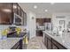 Modern kitchen featuring granite countertops, stainless appliances, and a functional layout at 3408 S 184Th Ln, Goodyear, AZ 85338