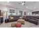 Expansive living room with plush brown leather furniture and natural light-filled open space at 3408 S 184Th Ln, Goodyear, AZ 85338