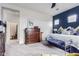 Stylish main bedroom featuring a large dresser, wood furniture and a relaxing bed with decorative pillows at 3408 S 184Th Ln, Goodyear, AZ 85338