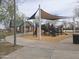 Community playground with climbing and play structures covered by a sun shade at 3408 S 184Th Ln, Goodyear, AZ 85338