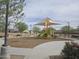 Community playground with shade cover features a slide, climbing structure, and benches at 3408 S 184Th Ln, Goodyear, AZ 85338