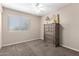 Cozy bedroom with dresser, carpet and natural lighting with neutral colors and carpeted floors at 3511 E Baseline Rd # 1076, Phoenix, AZ 85042