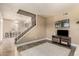 Spacious living room featuring a staircase, neutral decor, and modern entertainment setup at 3511 E Baseline Rd # 1076, Phoenix, AZ 85042