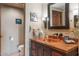 Half-bathroom with copper sink and wood vanity at 36601 N Mule Train N Rd # D16, Carefree, AZ 85377