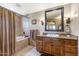 Bathroom featuring a soaking tub and wood vanity at 36601 N Mule Train N Rd # D16, Carefree, AZ 85377