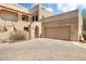 Inviting exterior view with a spacious three-car garage at 36601 N Mule Train N Rd # D16, Carefree, AZ 85377