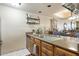 Functional kitchen area with countertops, wooden cabinets, and a view into the adjacent dining space at 36601 N Mule Train N Rd # D16, Carefree, AZ 85377