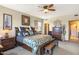 Spacious main bedroom features a ceiling fan, bedside table, dresser, and stylish decorative accents at 36601 N Mule Train N Rd # D16, Carefree, AZ 85377