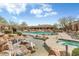 Resort style pool featuring a waterfall, lounge chairs, and cacti landscaping at 36601 N Mule Train N Rd # D16, Carefree, AZ 85377