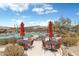 Community pool with desert landscape, lounge chairs, tables, and outdoor seating at 36601 N Mule Train N Rd # D16, Carefree, AZ 85377