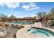 Resort-style community pool area with hot tub, lounge chairs, and lush desert landscaping at 36601 N Mule Train N Rd # D16, Carefree, AZ 85377