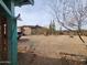 Wide shot of the backyard with gravel ground, solar panel, and desert foliage at 37448 N 301St Ave, Wittmann, AZ 85361