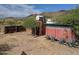 Exterior view of the home with foliage, fence and desert landscape at 37448 N 301St Ave, Wittmann, AZ 85361