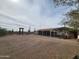 Exterior view of the open garage structure and surrounding desert landscape at 37448 N 301St Ave, Wittmann, AZ 85361