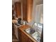 The kitchen sink with stainless steel basin, wooden counter, and lots of cabinets at 37448 N 301St Ave, Wittmann, AZ 85361