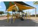 Neighborhood playground with climbing structures, slides, and colorful shade canopies for fun outdoor activities at 38055 W Bello Ln, Maricopa, AZ 85138