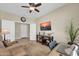 Comfortable living area with a ceiling fan, TV, and neutral decor at 3931 N 163Rd Dr, Goodyear, AZ 85395