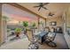 Covered patio with outdoor seating, ceiling fans, a grill and a beautiful sunset sky at 3931 N 163Rd Dr, Goodyear, AZ 85395