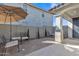 Cozy back patio features a sun umbrella with charming patio furniture and well-maintained landscaping at 41260 W Palmyra Ln, Maricopa, AZ 85138