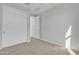 Well-lit bedroom featuring neutral carpeting and large closets at 41260 W Palmyra Ln, Maricopa, AZ 85138