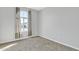 Well-lit bedroom featuring neutral carpeting and a large window at 41260 W Palmyra Ln, Maricopa, AZ 85138