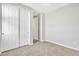 Well-lit bedroom featuring neutral carpeting and large closets at 41260 W Palmyra Ln, Maricopa, AZ 85138