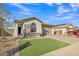 Beautiful single-story home featuring a manicured front yard and a paver driveway leading to a two-car garage at 41260 W Palmyra Ln, Maricopa, AZ 85138