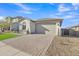 Attractive home boasting a manicured front yard and a paver driveway leading to a two-car garage at 41260 W Palmyra Ln, Maricopa, AZ 85138