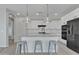 Stylish kitchen island with granite countertops, pendant lighting, and a sleek black faucet at 41260 W Palmyra Ln, Maricopa, AZ 85138