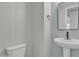 Well-lit powder room featuring a pedestal sink with decorative tile backsplash at 41260 W Palmyra Ln, Maricopa, AZ 85138