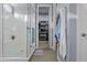 Modern bathroom boasts a glass shower and leads to a walk-in closet with organized shelving at 4457 E Bernice St, Gilbert, AZ 85295