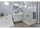 Bright bathroom featuring a large tub and glass-enclosed shower with gray tile flooring and light blue walls at 4457 E Bernice St, Gilbert, AZ 85295