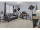 Bedroom with neutral carpet, a dark gray couch, computer desk, guitar and recording equipment at 4457 E Bernice St, Gilbert, AZ 85295