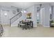 Dining room with tile floor, modern chandelier, and staircase at 4457 E Bernice St, Gilbert, AZ 85295