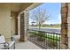 Cozy front porch with stone pillars and iron railing overlooking a quiet street and neighborhood park at 4457 E Bernice St, Gilbert, AZ 85295