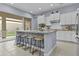 Stylish kitchen island with granite countertops, custom tile accents, and seating for four at 4457 E Bernice St, Gilbert, AZ 85295