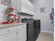 Well-organized laundry room with white cabinets, granite countertop, and modern washer and dryer at 4457 E Bernice St, Gilbert, AZ 85295