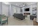 Inviting living room featuring a modern fireplace, tile floors, and neutral color palette at 4457 E Bernice St, Gilbert, AZ 85295