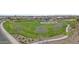 Aerial view of neighborhood park with green space, playground, basketball court, walking paths, and desert landscaping at 4457 E Bernice St, Gilbert, AZ 85295