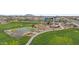 Aerial view of neighborhood park featuring basketball court, playground, picnic benches, and green space at 4457 E Bernice St, Gilbert, AZ 85295