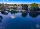 Aerial of a lakefront home with solar panels, boat docks, and serene water views at 4881 S Vista Pl, Chandler, AZ 85248