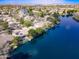 Stunning aerial view showcasing waterfront homes, solar panels, and a serene lake community at 4881 S Vista Pl, Chandler, AZ 85248